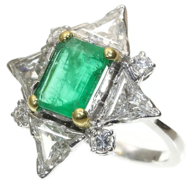 Impressive diamond and emerald engagement ring with big triangle cut diamonds